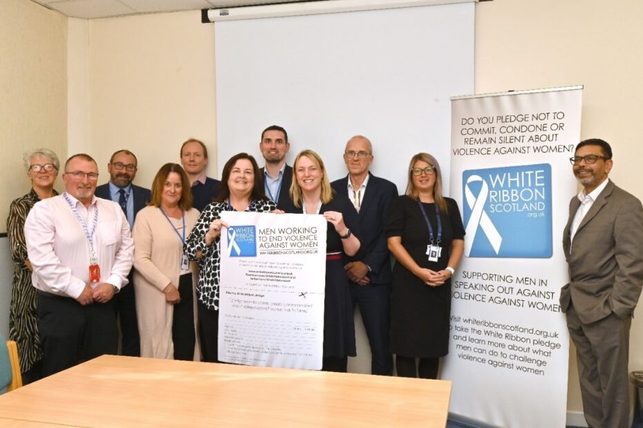 Members of Ayrshire and Arran NHS Board holding white ribbon pledge sign