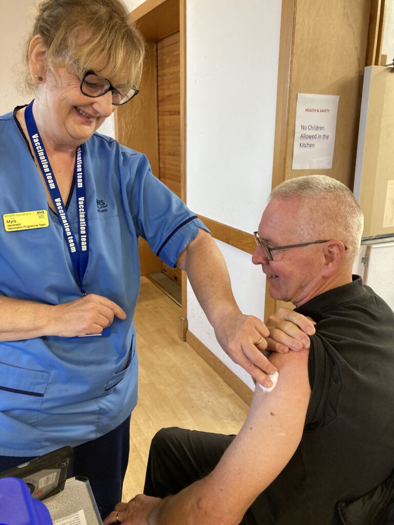 Male patient after receiving seasonal flu vaccination from female vaccinator
