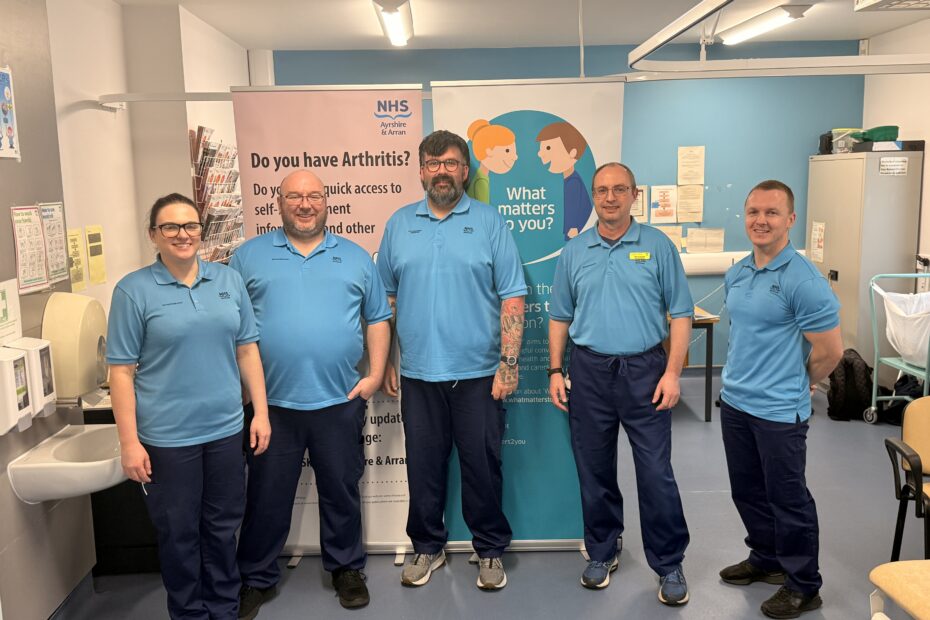 MSK Staff standing in clinical room from left to right are: Christina Starrs (Advanced Practice Physiotherapist), Mark Duffy (Advanced Practice Physiotherapist), Martyn Lopez (MSK Occupational Therapist), Brian Scarisbrick (Advanced Practice Physiotherapist), Adam Stewart (Advanced Practice Physiotherapist)