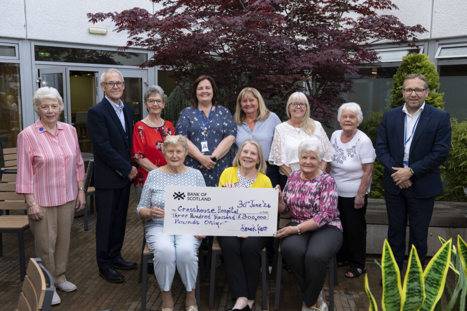 Group of people presenting a large cheque