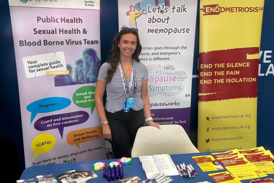 Staff standing behind the stall at the event