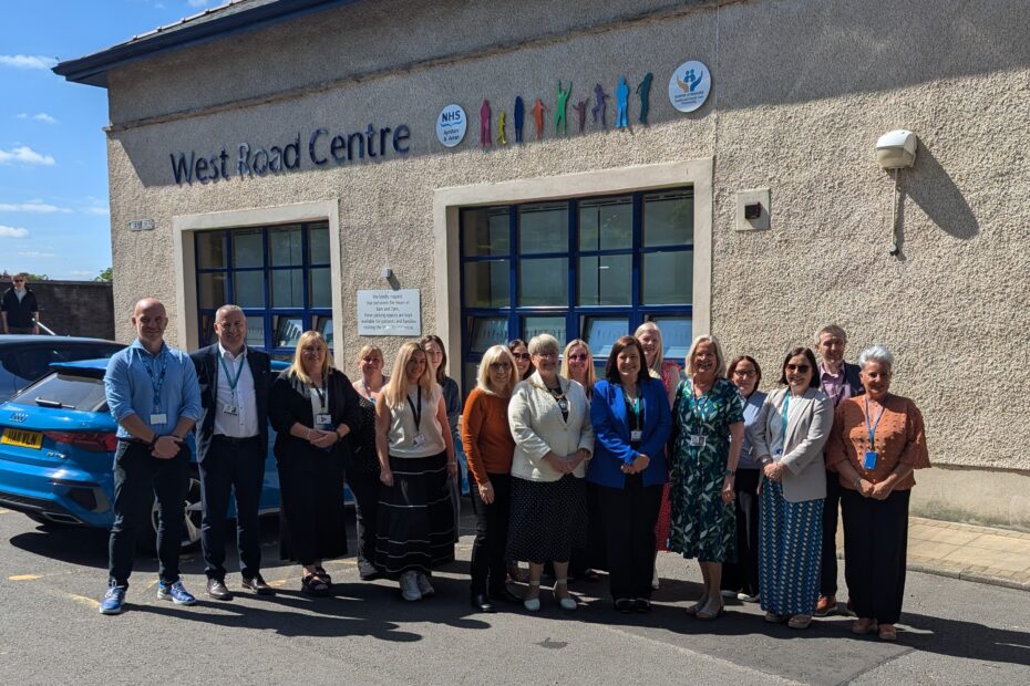 Official opening of West Road building shows a group of colleagues standing in front of the entrance to the building.