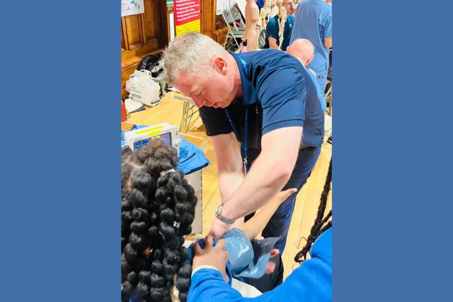 NHS Ayrshire & Arran staff demonstrating blood pressure with child at job fair
